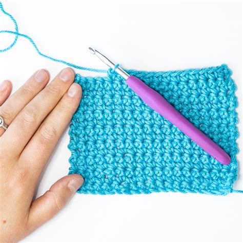 Step 1: Hold crochet hook in right hand and make a slip knot on hook. Step 2: Bring yarn over hook from back to front and grab it with hook. Step 3: Draw hooked yarn through slip knot and onto hook. This makes one chain stitch. Repeat Steps 2 and 3 in sequence 28 more times. 